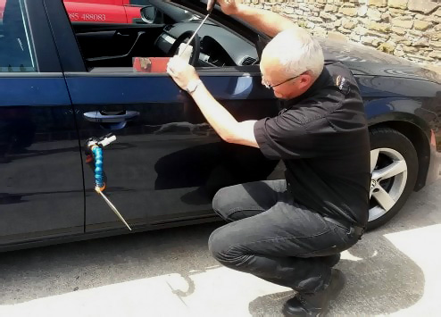 We can repair some dents without the need for paint or respraying Photo of paintless dent removal being performed